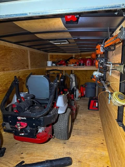 Zero-turn mower, trimmers and blowers loaded in the Miklus enclosed trailer